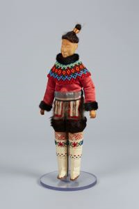 Image: West Greenland doll in costume, beaded collar, tall white boots, topknot
